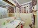 Bathroom featuring floral wallpaper, tiled walls, and classic fixtures; ready for remodeling at 121 Patrick St, Gastonia, NC 28054