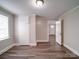 Bedroom with a window and closet, featuring new vinyl plank flooring at 121 Patrick St, Gastonia, NC 28054