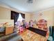 Bedroom featuring a play kitchen and wooden floors, perfect for a creative space at 121 Patrick St, Gastonia, NC 28054