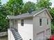Exterior view of the home's stairwell, garage, and part of the yard at 121 Patrick St, Gastonia, NC 28054