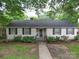 Charming one-story home featuring a symmetrical design, manicured landscaping, and inviting walkway at 121 Patrick St, Gastonia, NC 28054