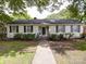 Charming one-story home featuring a symmetrical design, manicured landscaping, and inviting walkway at 121 Patrick St, Gastonia, NC 28054