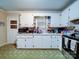 Functional kitchen featuring white cabinetry, stainless steel appliances, and tile flooring at 121 Patrick St, Gastonia, NC 28054