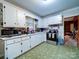 Functional kitchen featuring white cabinetry, stainless steel appliances, and tile flooring at 121 Patrick St, Gastonia, NC 28054