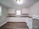Kitchen featuring all white cabinets and modern flooring at 121 Patrick St, Gastonia, NC 28054