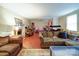 Spacious living room with a cozy fireplace, comfortable seating, and hardwood floors at 121 Patrick St, Gastonia, NC 28054