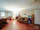 Spacious living room with a cozy fireplace, comfortable seating, and hardwood floors at 121 Patrick St, Gastonia, NC 28054