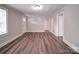 Living room featuring a window, vinyl flooring, and an open doorway at 121 Patrick St, Gastonia, NC 28054
