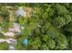 A lush aerial view of the homes, backyards, foot bridge, and pools at 1369 Timberlane Ter, Mooresville, NC 28115