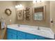 Stylish bathroom featuring a double sink vanity with bright blue cabinets and decor, complemented by neutral wall color at 1369 Timberlane Ter, Mooresville, NC 28115