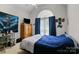 Bedroom with blue bedding, large window and blue curtains for a cozy and inviting space to unwind at 1369 Timberlane Ter, Mooresville, NC 28115