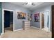 Spacious bedroom with neutral carpeting, light gray walls, and multiple doorways at 1369 Timberlane Ter, Mooresville, NC 28115
