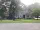 Charming single-story home with a well-manicured lawn and classic architectural details at 1369 Timberlane Ter, Mooresville, NC 28115