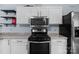 Close-up of kitchen appliances including an oven, microwave, and stainless steel refrigerator at 1369 Timberlane Ter, Mooresville, NC 28115