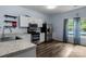 Stylish kitchen featuring stainless steel appliances, sleek white cabinets, and a view of the pool at 1369 Timberlane Ter, Mooresville, NC 28115