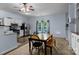 Bright kitchen with stainless steel appliances, white cabinets, and a breakfast table with a view to the pool at 1369 Timberlane Ter, Mooresville, NC 28115