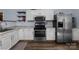 Modern kitchen featuring stainless steel appliances and white cabinets for a clean, contemporary look at 1369 Timberlane Ter, Mooresville, NC 28115