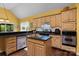 Charming kitchen features an island, granite countertops, stainless steel appliances, and ample cabinet space for storage at 1369 Timberlane Ter, Mooresville, NC 28115