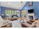 Bright living room with vaulted ceiling, fireplace, hardwood floors, and an abundance of natural light from large windows at 1369 Timberlane Ter, Mooresville, NC 28115