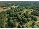 Aerial view showcases a residential area surrounded by lush trees and greenery, marked with a red arrow at 143 Hallman St, Cherryville, NC 28021