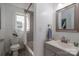 Bright bathroom with a vanity, updated fixtures, a shower and tub combination, and a window at 143 Hallman St, Cherryville, NC 28021