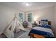 Comfortable bedroom with a cozy tent, stylish bedding, side table, and natural light from the windows at 143 Hallman St, Cherryville, NC 28021