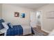 Inviting bedroom with decoratively themed wall art, hardwood floors, and a cozy striped throw blanket at 143 Hallman St, Cherryville, NC 28021