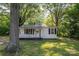 Charming one-story home surrounded by lush trees and a well-manicured lawn at 143 Hallman St, Cherryville, NC 28021