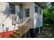 Exterior side entry view of home showing wooden steps, electrical panel, and freshly painted trim at 143 Hallman St, Cherryville, NC 28021