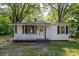 Charming one-story home with a welcoming front porch and well-maintained landscaping at 143 Hallman St, Cherryville, NC 28021