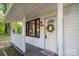 Charming front porch showcasing decorative wreath, 'HOME' sign and window view at 143 Hallman St, Cherryville, NC 28021