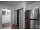 Storage area features a stainless refrigerator and curtain for privacy and organization at 143 Hallman St, Cherryville, NC 28021