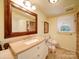 Bathroom with a sink, vanity, mirror, toilet, and decorative window at 157 Old Hearth Rd, Clover, SC 29710