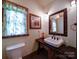Charming bathroom with rustic wood accents, decorative mirror, and unique sink at 157 Old Hearth Rd, Clover, SC 29710