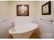 Bathroom with claw foot tub, wainscoting, and neutral paint at 157 Old Hearth Rd, Clover, SC 29710