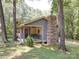 Charming cabin featuring a stone chimney and a cozy porch swing for relaxing outdoors at 157 Old Hearth Rd, Clover, SC 29710