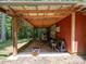View of the covered patio with wooden beams, perfect for outdoor projects and storage at 157 Old Hearth Rd, Clover, SC 29710