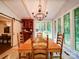 Formal dining area with wood furniture, chandelier, and large windows overlooking greenery at 157 Old Hearth Rd, Clover, SC 29710