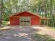 Exterior view of the rustic outbuilding showcasing its large sliding door and covered area at 157 Old Hearth Rd, Clover, SC 29710