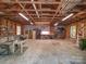 Spacious garage interior with exposed ceiling beams and ample storage and workspace at 157 Old Hearth Rd, Clover, SC 29710