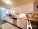Updated kitchen with white cabinets, stainless appliances, and modern backsplash at 157 Old Hearth Rd, Clover, SC 29710