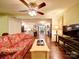 Open living room with hardwood floors and a ceiling fan that leads to the dining room and kitchen at 157 Old Hearth Rd, Clover, SC 29710