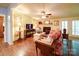 Bright living room with a fireplace, a ceiling fan and hardwood floors, creating a warm atmosphere at 157 Old Hearth Rd, Clover, SC 29710