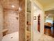 Tile shower with built-in seat and shelves, with a view into the bedroom at 157 Old Hearth Rd, Clover, SC 29710