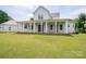 Back of house featuring a large covered porch, ceiling fans, and ample seating space at 1621 Lakefield Cir, Gastonia, NC 28056