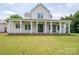 Rear view of home featuring a large covered porch, ceiling fans, and ample seating space at 1621 Lakefield Cir, Gastonia, NC 28056
