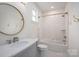 Bright bathroom featuring subway tiles in the shower, white vanity and a round mirror at 1621 Lakefield Cir, Gastonia, NC 28056