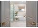 Luxurious bathroom with a standalone tub, glass-enclosed shower, and marble tile flooring at 1621 Lakefield Cir, Gastonia, NC 28056