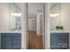 Stylish bathroom with double vanities, modern fixtures, and wood flooring at 1621 Lakefield Cir, Gastonia, NC 28056