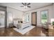 Bright bedroom featuring hardwood floors, with natural light and an access door to the outside at 1621 Lakefield Cir, Gastonia, NC 28056